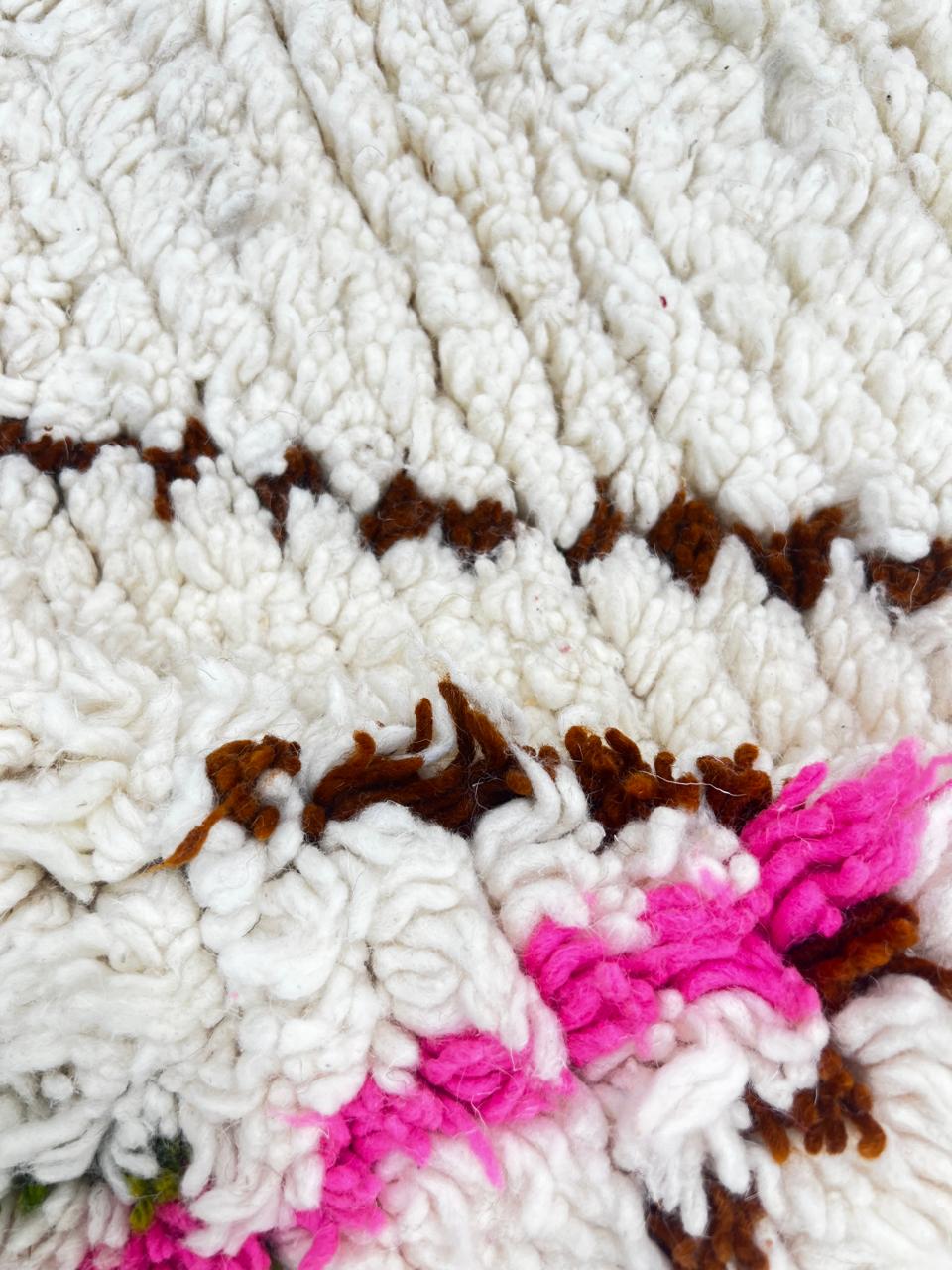 Round colorful Moroccan Berber rug with multicolor diamond motifs on a cream-white wool base