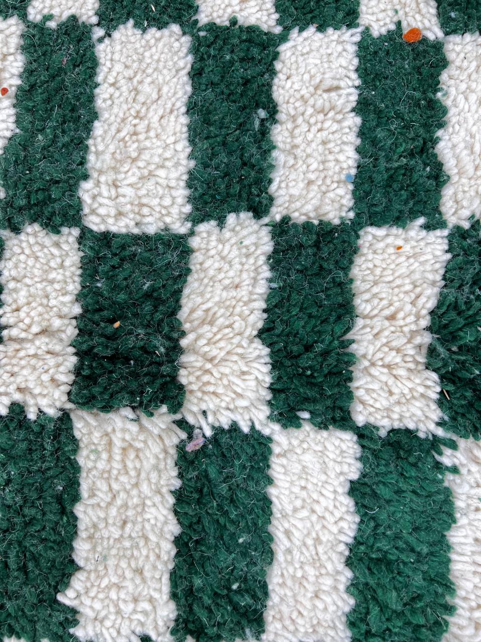 Round Moroccan wool rug with green and white checkerboard design, handmade checkered carpet