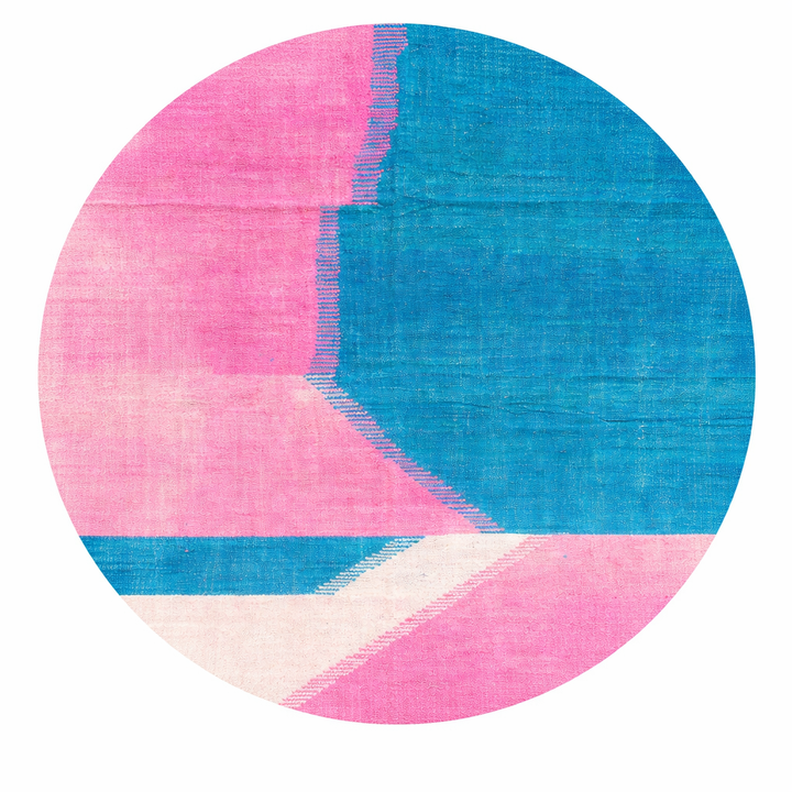 Handmade round Moroccan kilim rug with flatweave design, featuring modern pink and blue color blocks with white accents.