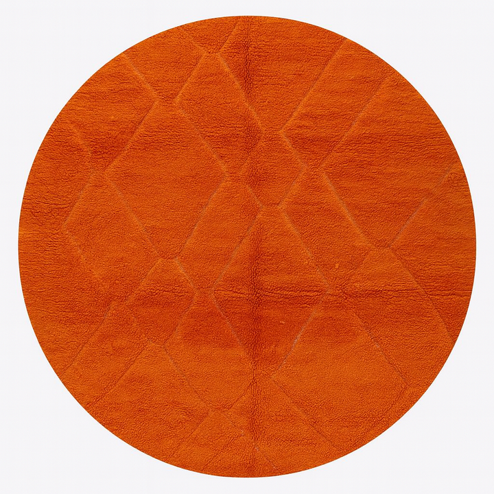 Round Moroccan rug in vibrant orange wool with carved diamond geometric pattern, handmade