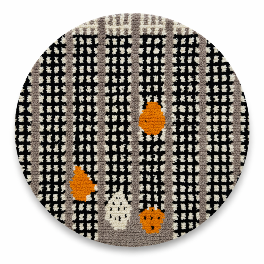 Round black and white Moroccan wool rug with abstract orange Berber motifs and textured grid pattern on white background