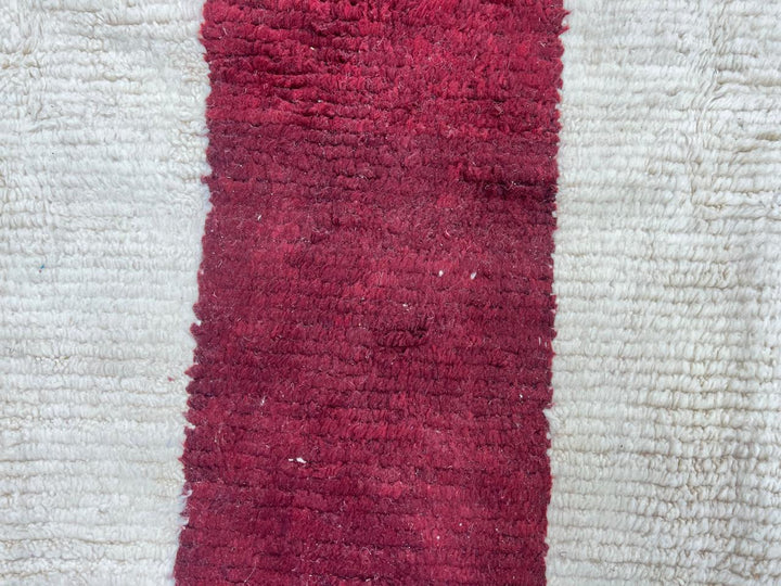 Round cream white Moroccan wool rug with burgundy and purple cross pattern