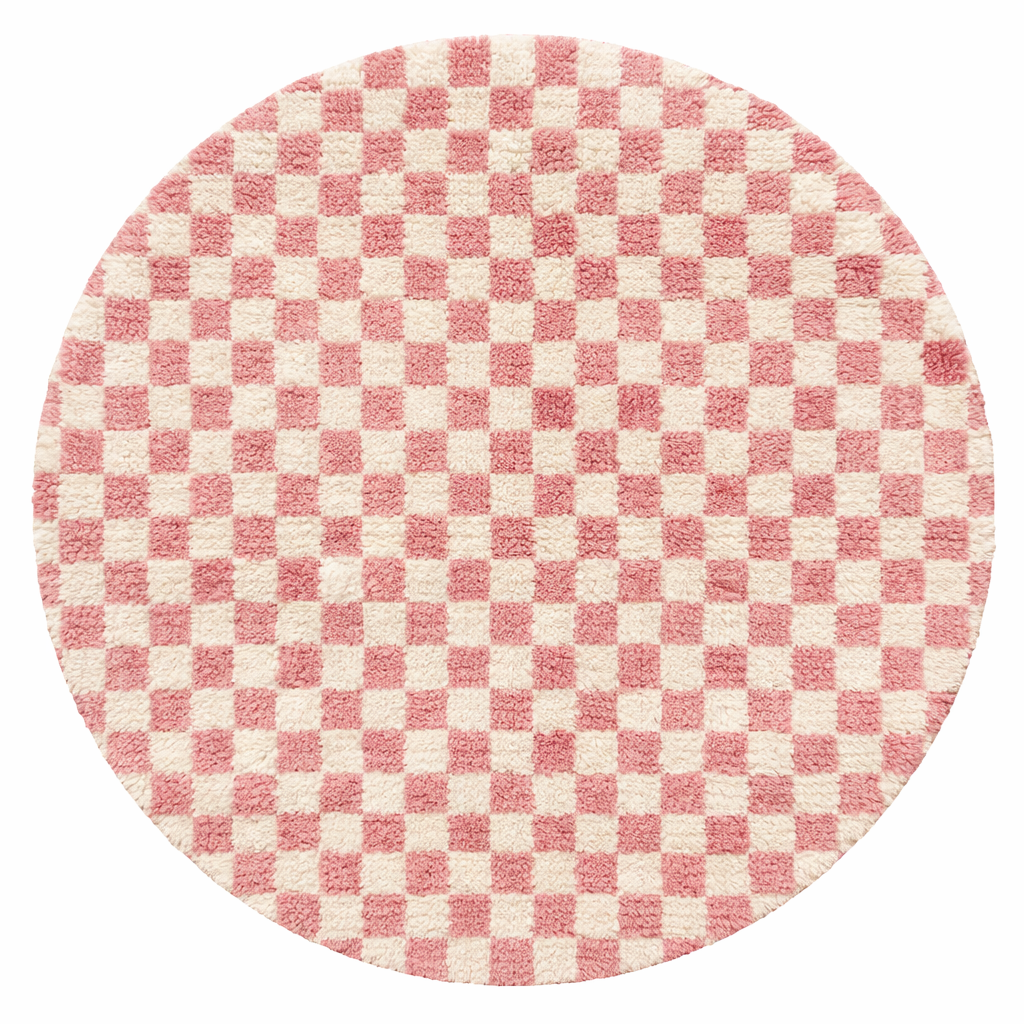 Handmade round Moroccan wool rug with pink and white checkerboard pattern, featuring a soft plush texture.