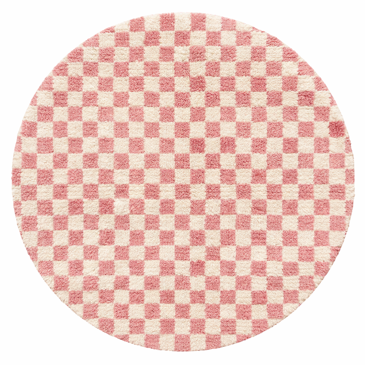 Handmade round Moroccan wool rug with pink and white checkerboard pattern, featuring a soft plush texture.