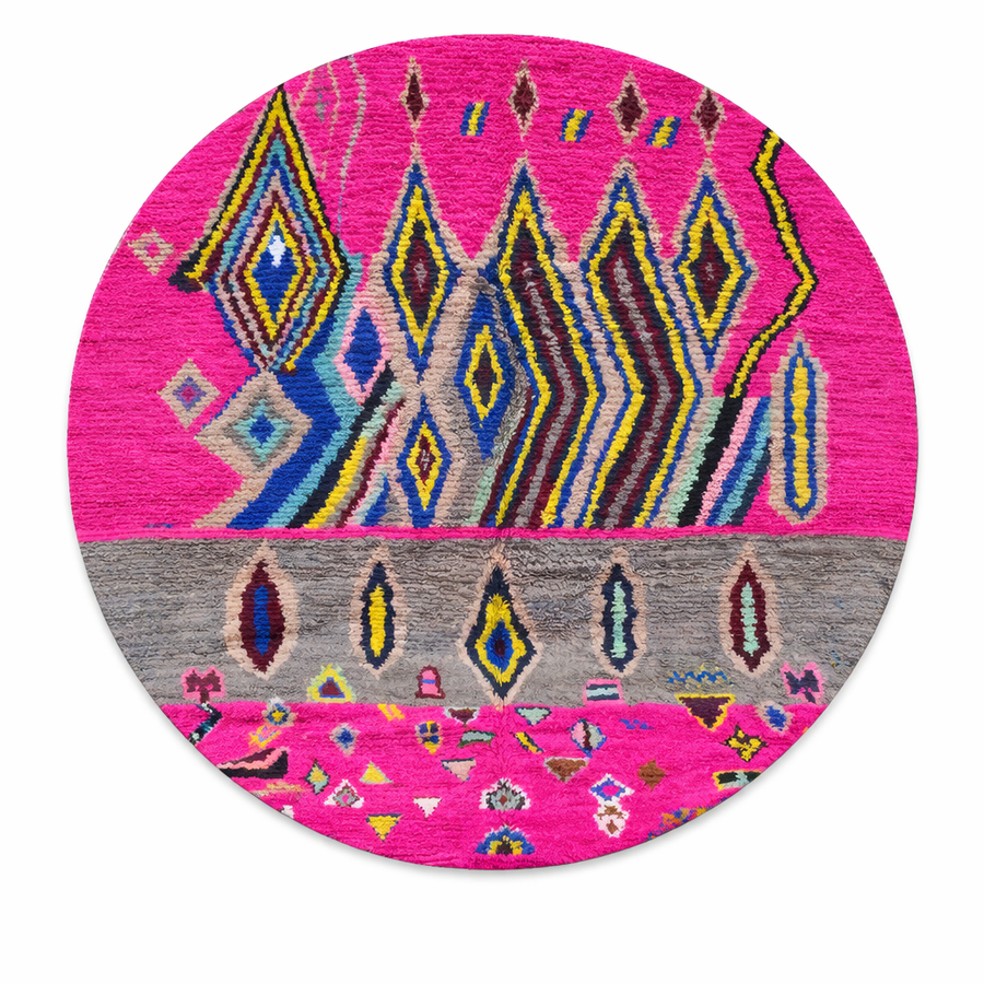 Round pink Moroccan wool rug with colorful Berber geometric patterns