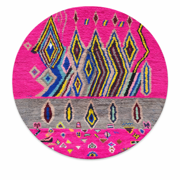 Round pink Moroccan wool rug with colorful Berber geometric patterns