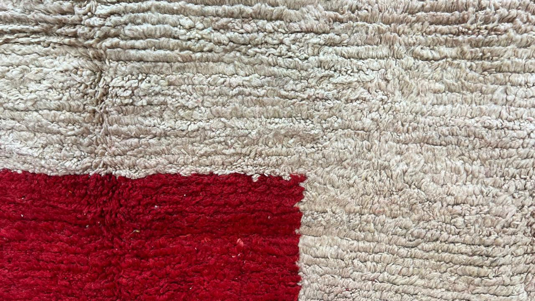 Handmade round Moroccan wool rug in red and beige color-block design