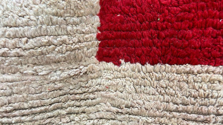 Handmade round Moroccan wool rug in red and beige color-block design