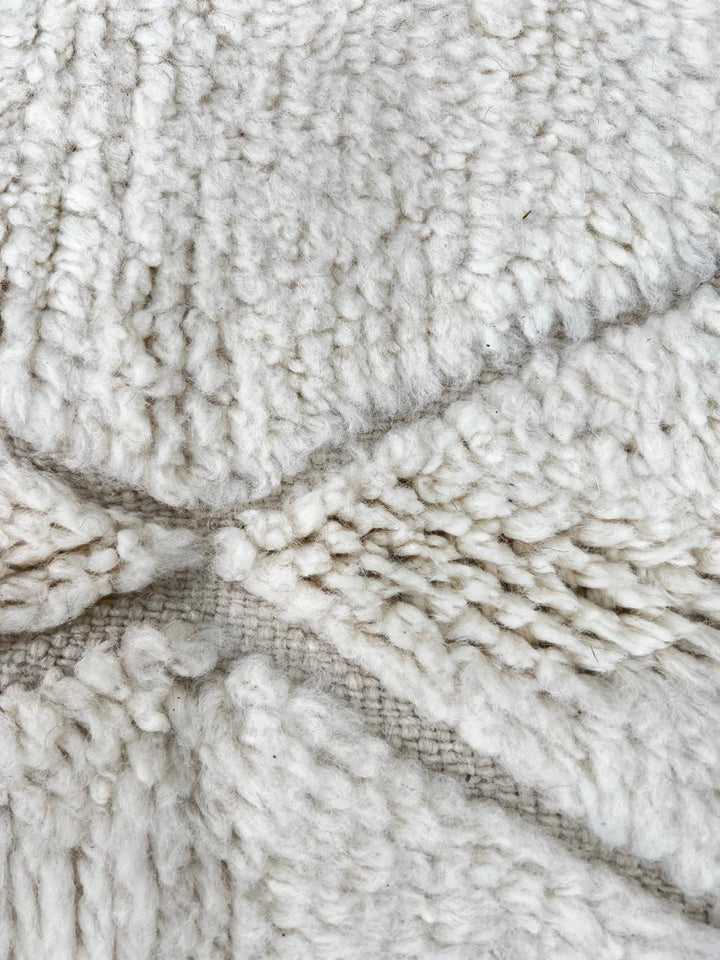 Round white Moroccan wool rug with subtle carved Berber line pattern