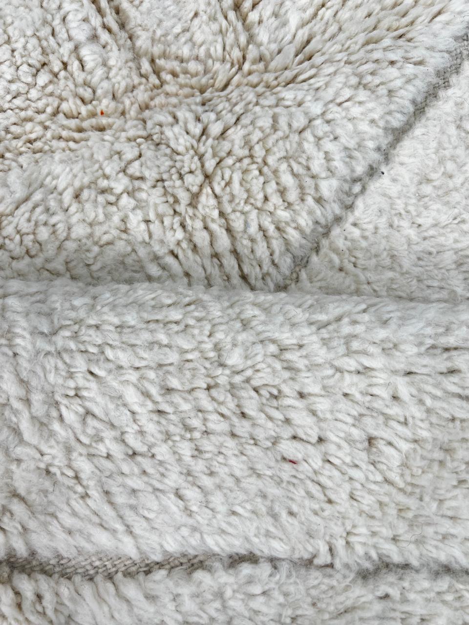 Round white Moroccan wool rug with subtle carved Berber line pattern