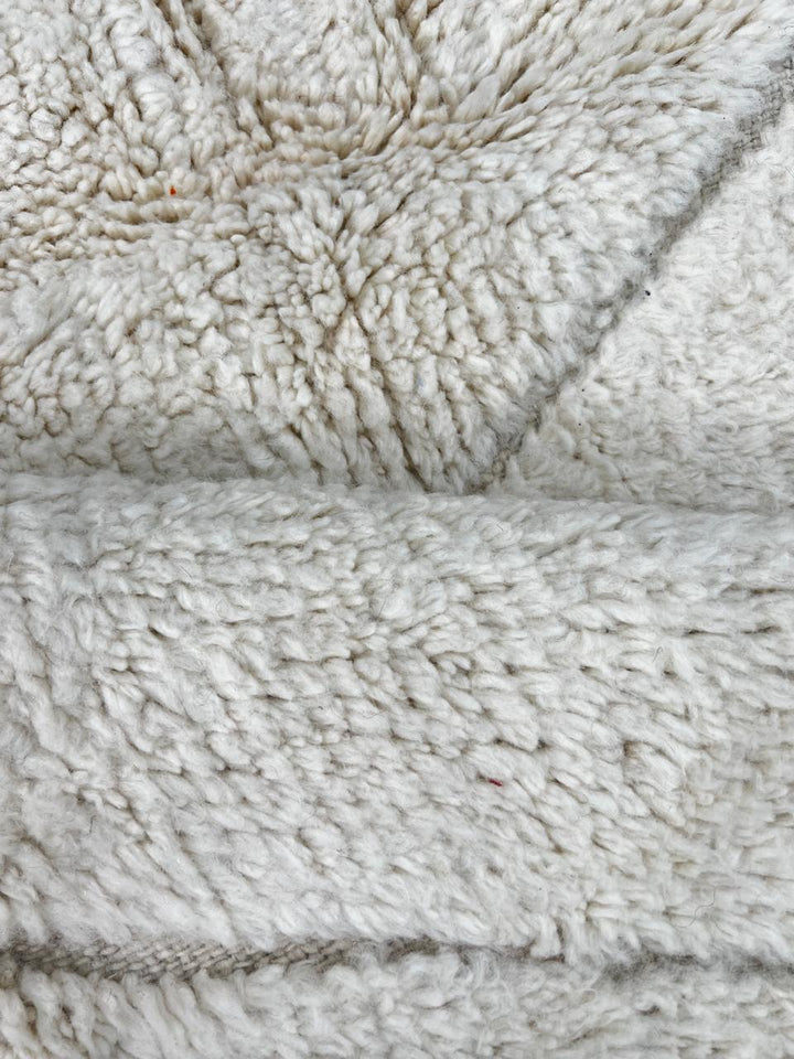 Round white Moroccan wool rug with subtle carved Berber line pattern