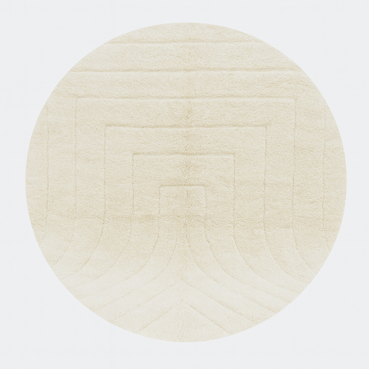 Round white Moroccan wool rug with subtle carved geometric line pattern