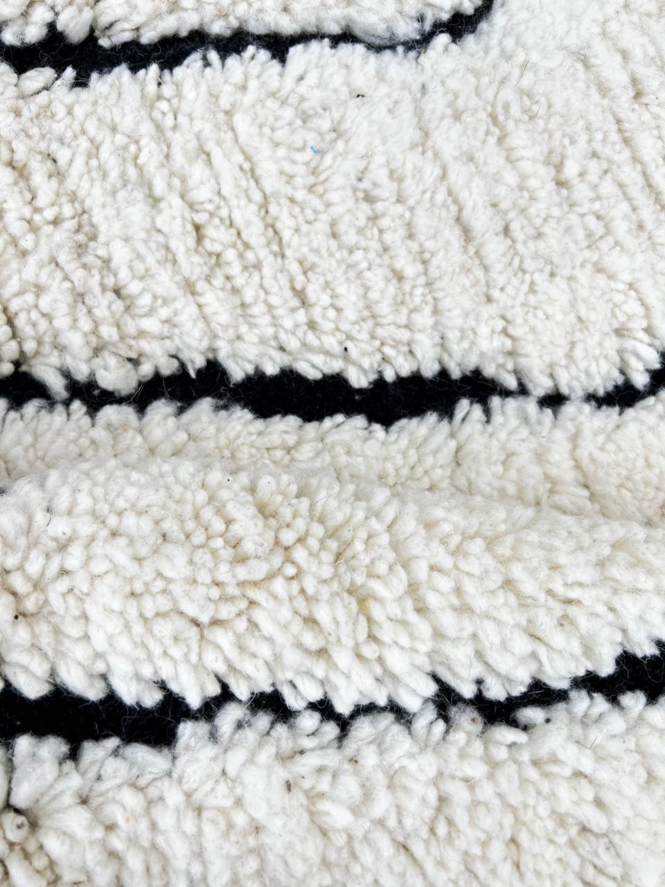 Round white Moroccan rug with black Berber diamond pattern