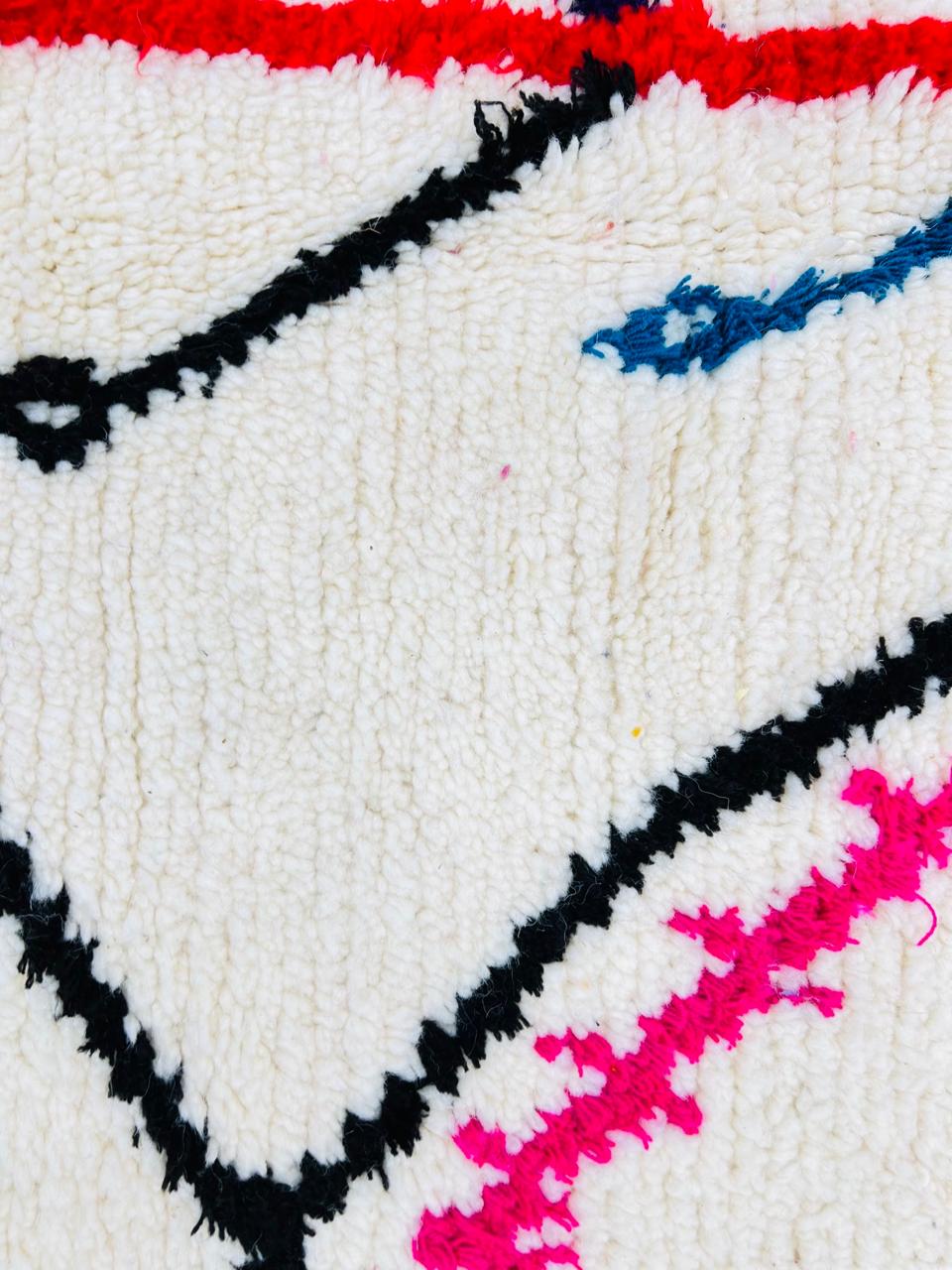 Handmade round Moroccan wool rug with colorful Berber symbols and black geometric lines