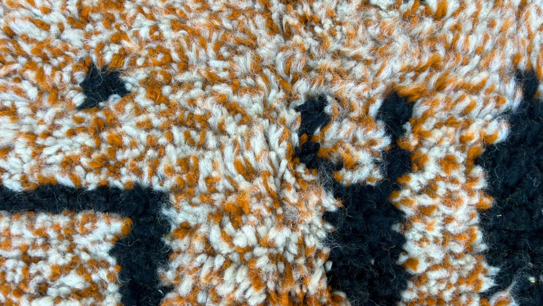 Handmade round Moroccan wool rug in yellow and black abstract Berber design
