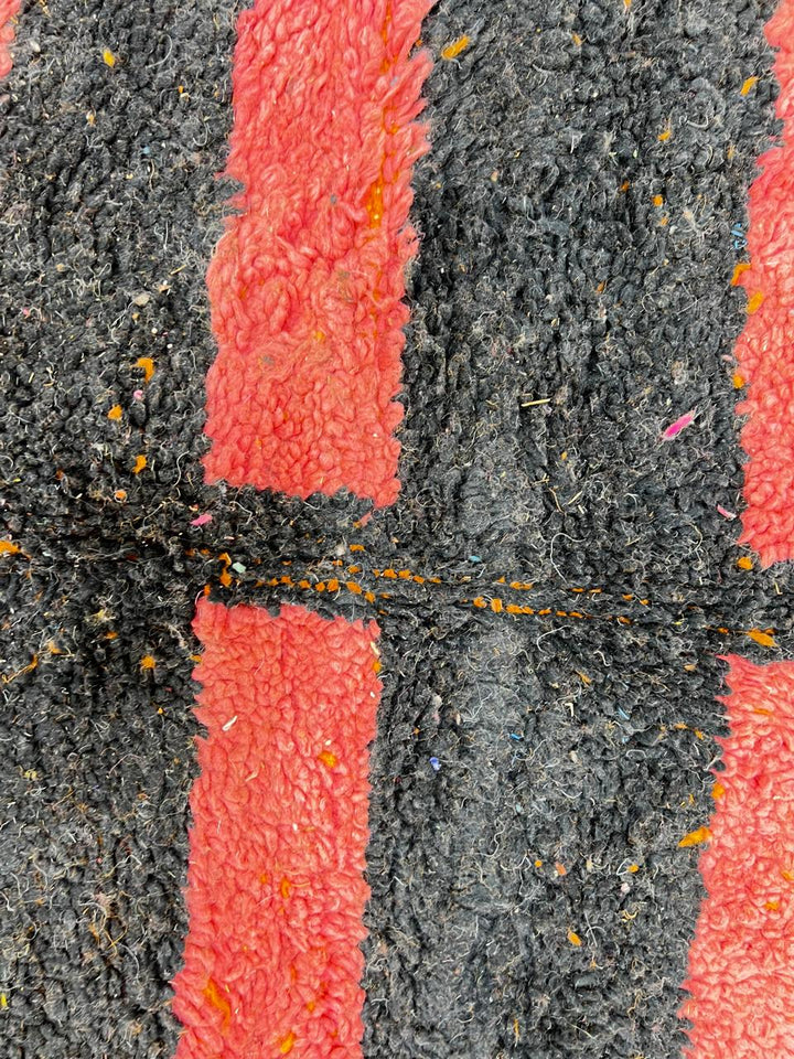 Round Moroccan Berber wool rug with abstract geometric motif, handmade by artisans.