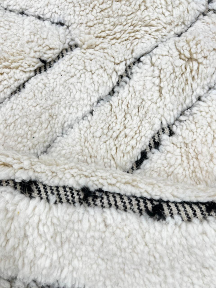 Round Beni Ourain Moroccan rug with white wool base and hand-drawn diamond pattern, handmade wool carpet