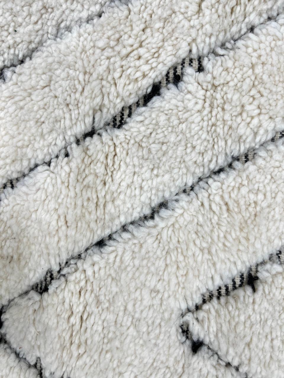 Round Beni Ourain Moroccan rug with white wool base and hand-drawn diamond pattern, handmade wool carpet