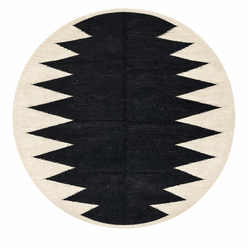 Handmade round Moroccan flatweave kilim rug with black and white zigzag geometric pattern, woven from natural wool.