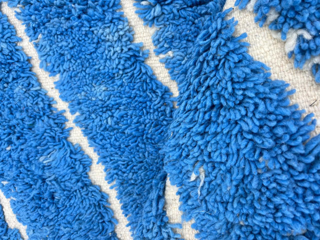 Round blue Moroccan wool rug with carved Berber line pattern and sculpted texture