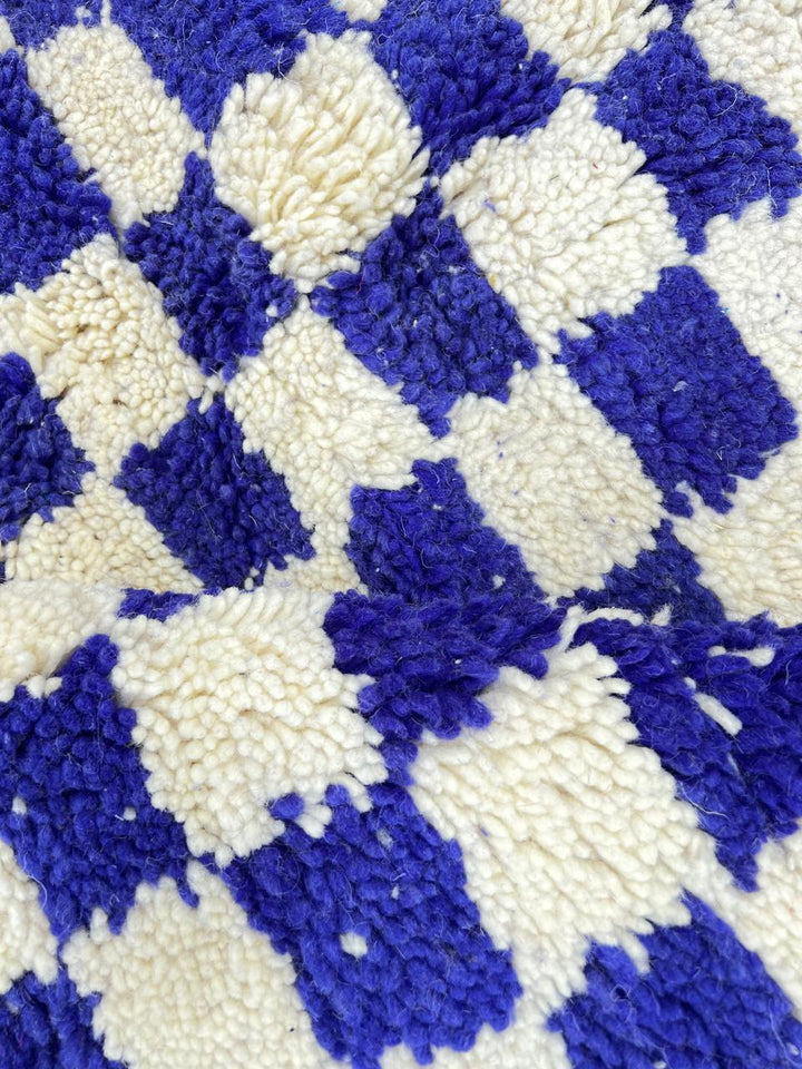 Round blue and white Moroccan checkered rug