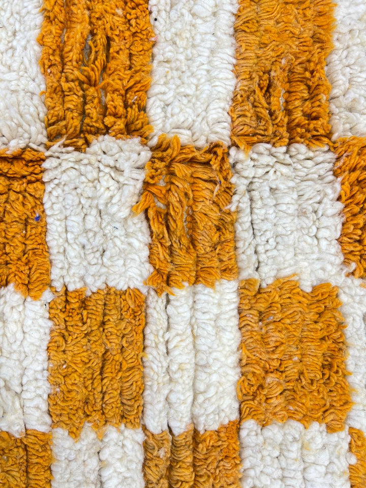 Handmade orange and white checkered Moroccan wool rug