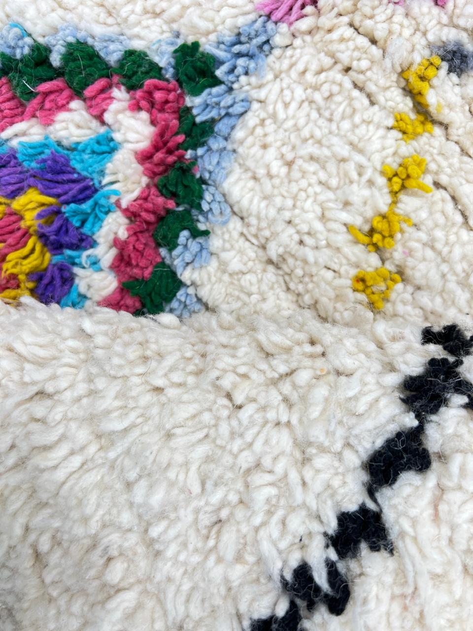 Round white Moroccan rug with multicolor Berber diamond patterns