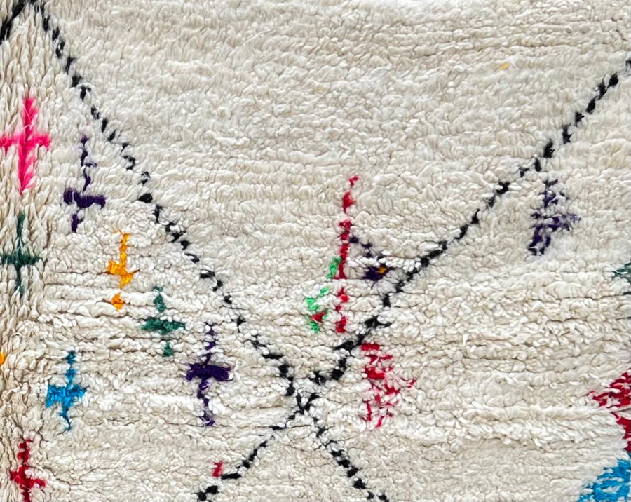 Round Moroccan Berber wool rug with colorful geometric patterns