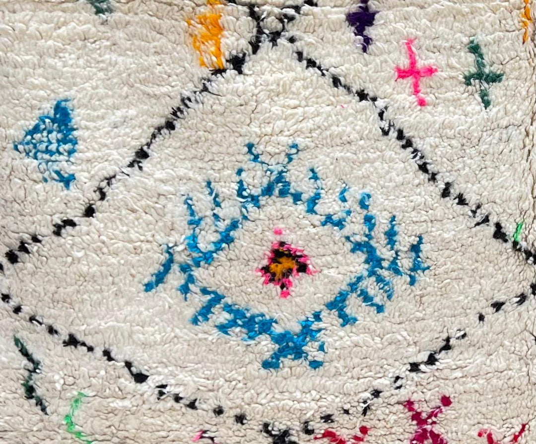 Round Moroccan Berber wool rug with colorful geometric patterns