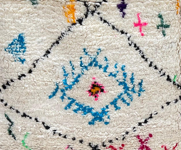 Round Moroccan Berber wool rug with colorful geometric patterns