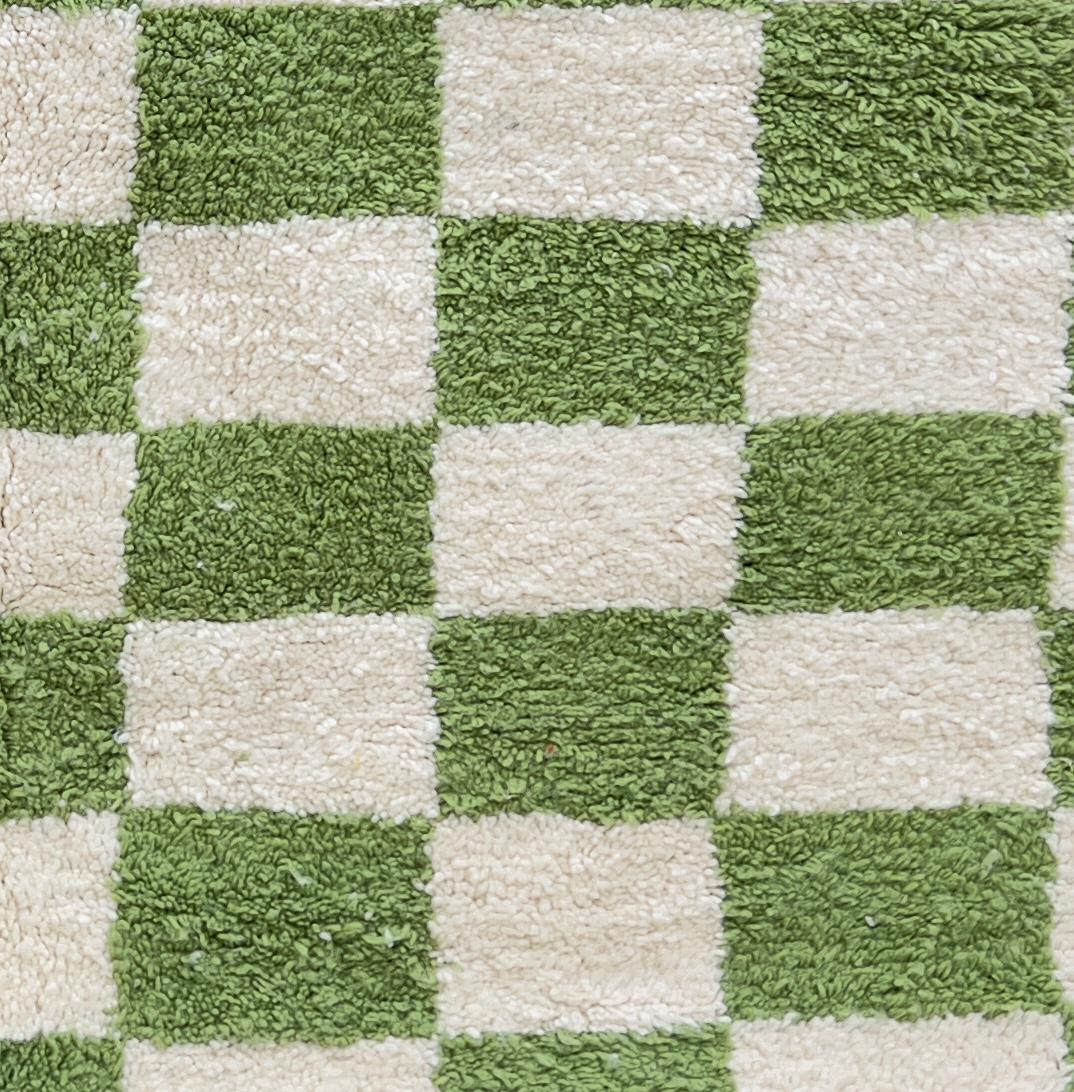 Round Moroccan wool rug with green and white checkered pattern, handmade plush checkerboard carpet