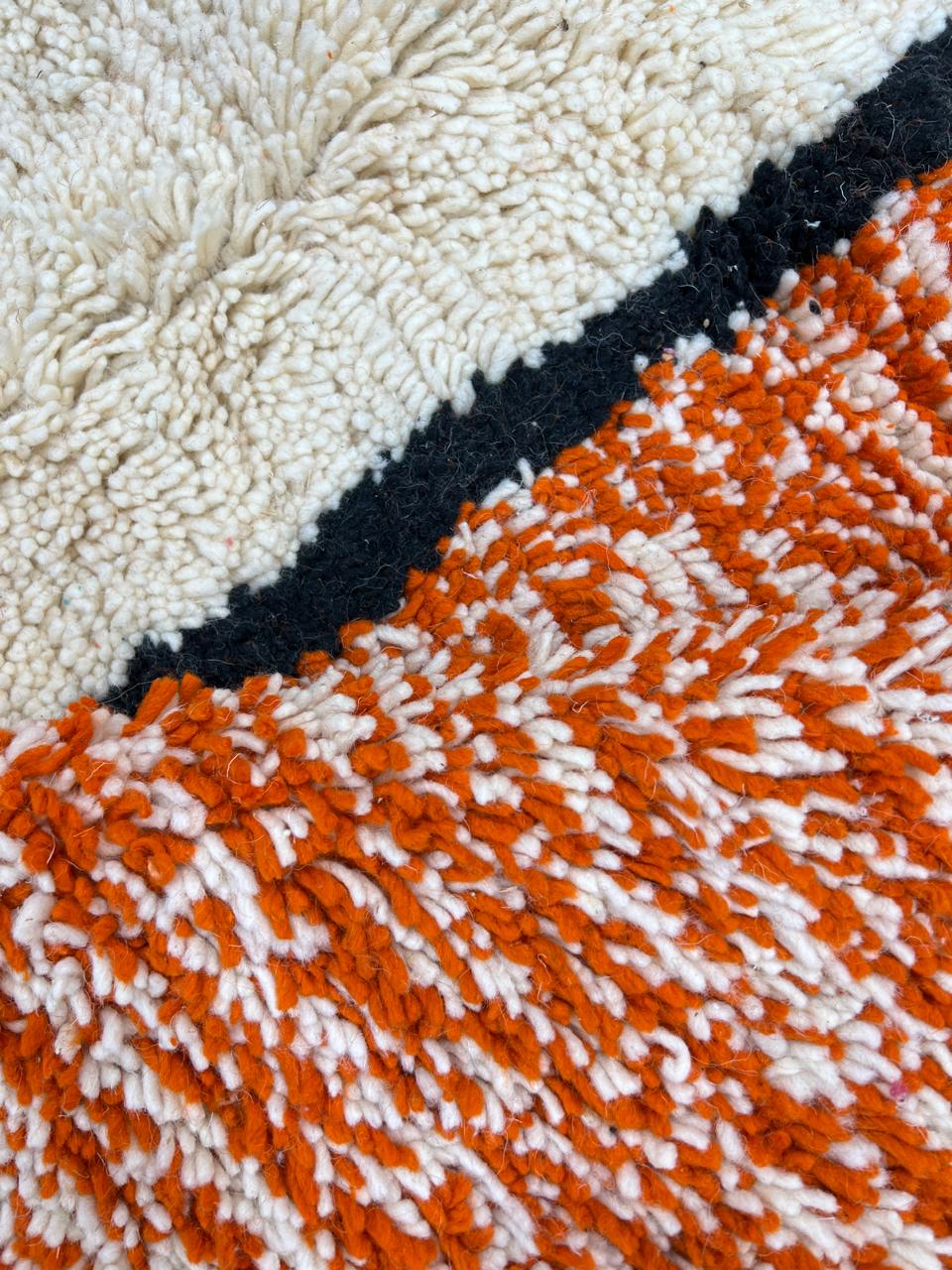 Round Moroccan rug with modern abstract geometric pattern in orange, white, black, teal, grey and rust tones, handmade wool design
