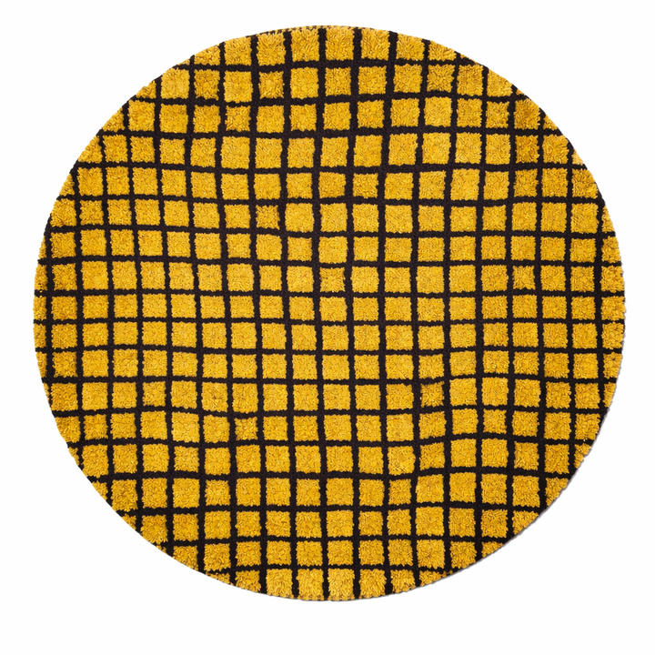 Round handmade Moroccan wool rug in mustard yellow with bold black grid pattern on white background
