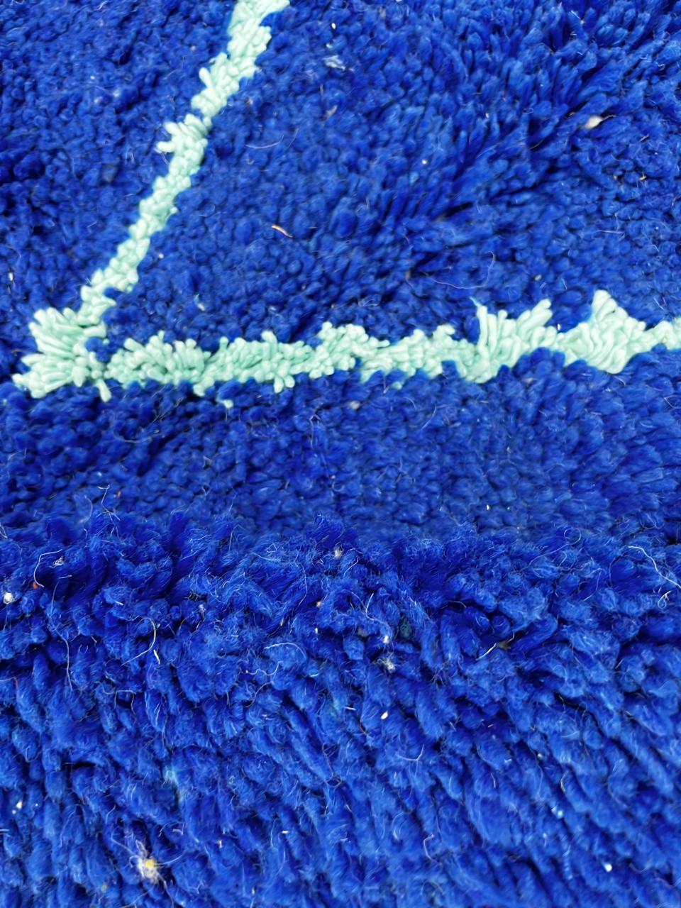 Handwoven royal-blue Moroccan wool rug with geometric light-blue diamond and line patterns