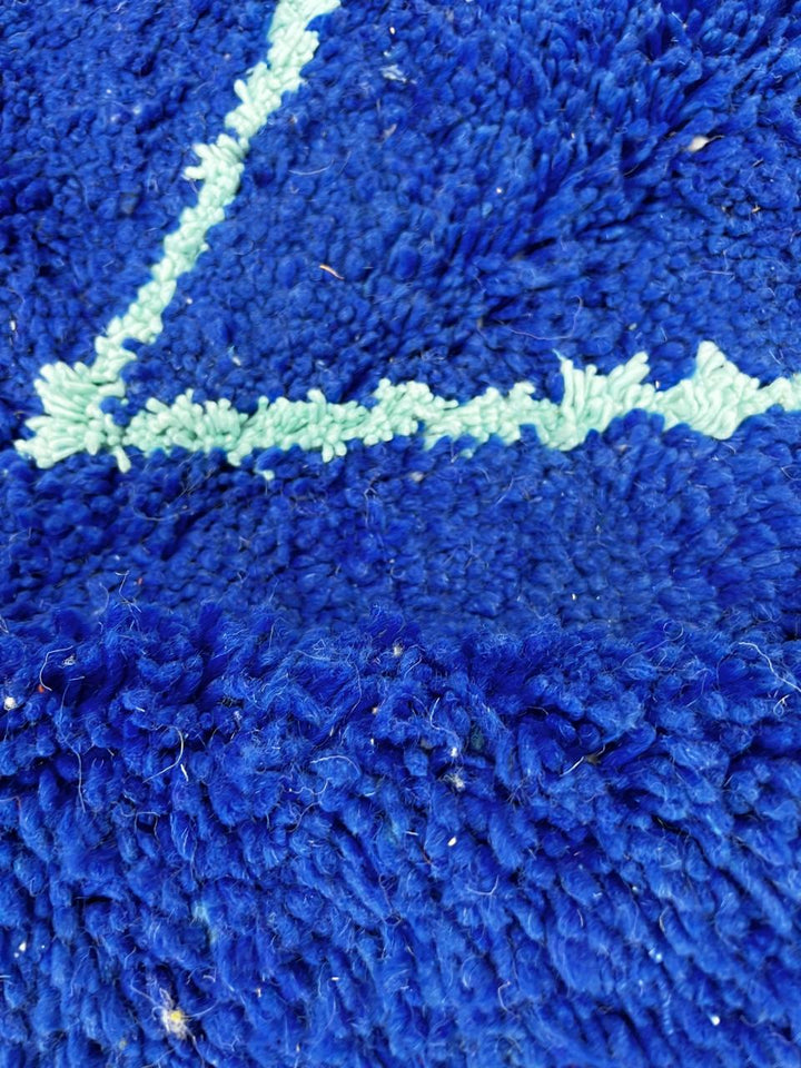 Handwoven royal-blue Moroccan wool rug with geometric light-blue diamond and line patterns