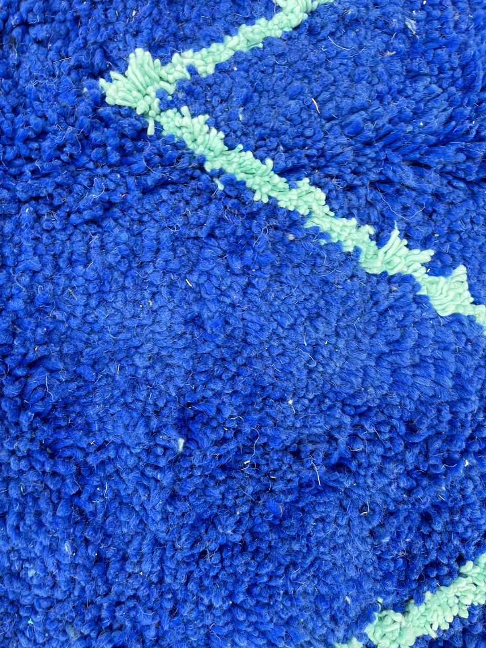 Handwoven royal-blue Moroccan wool rug with geometric light-blue diamond and line patterns