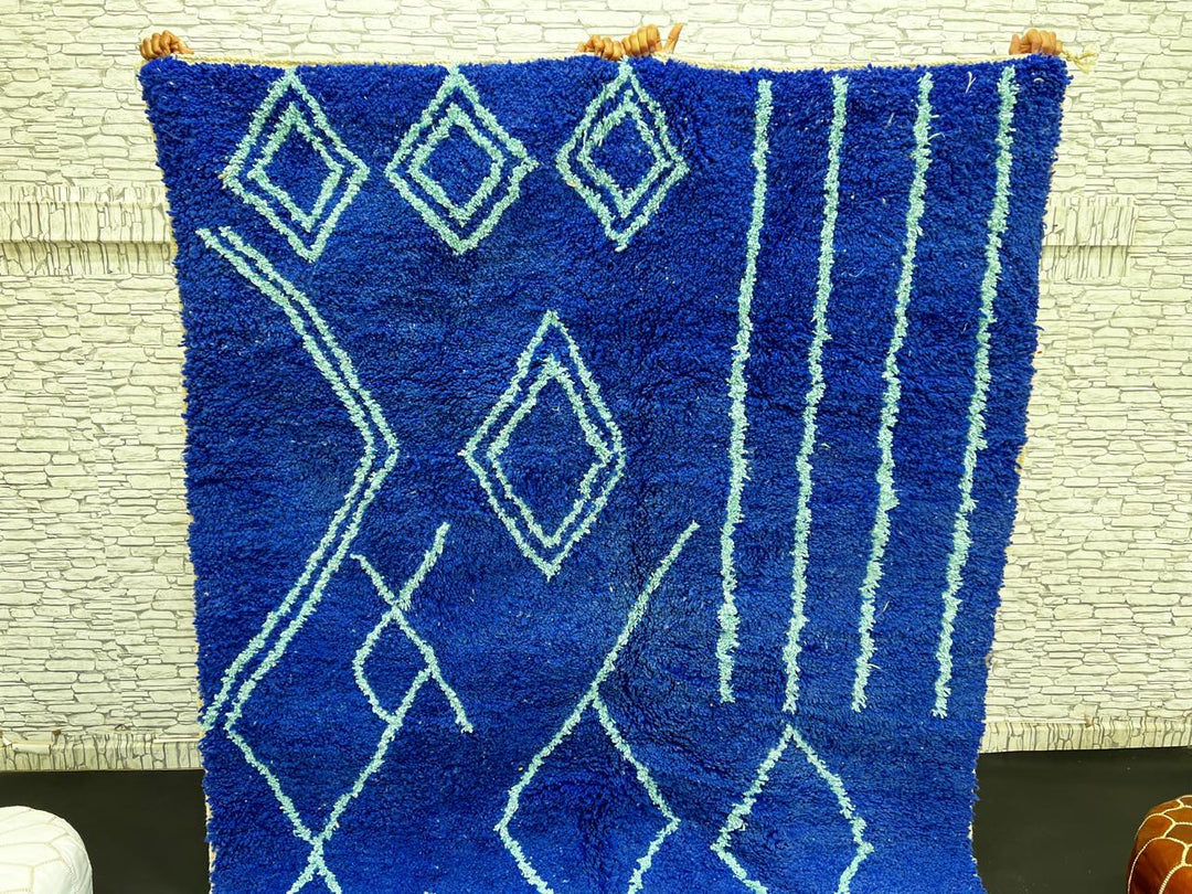 Handwoven royal-blue Moroccan wool rug with geometric light-blue diamond and line patterns