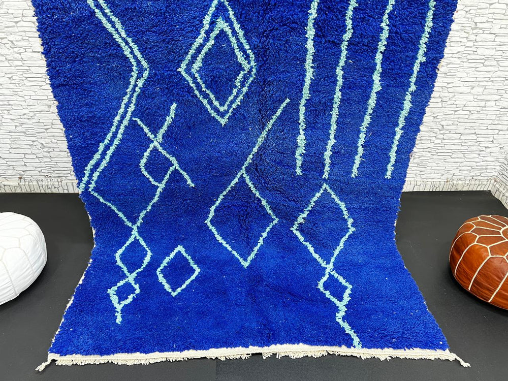 Handwoven royal-blue Moroccan wool rug with geometric light-blue diamond and line patterns
