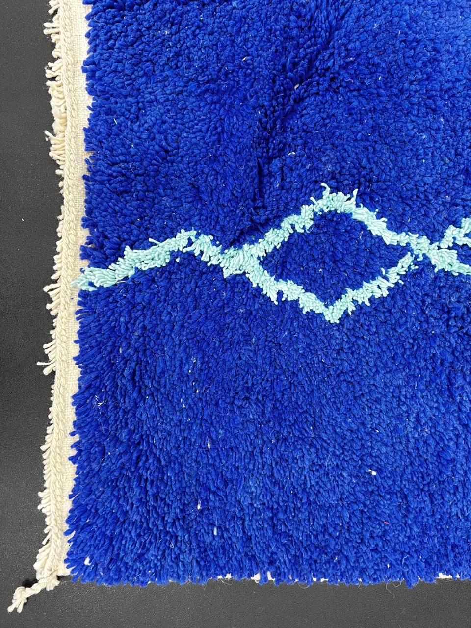 Handwoven royal-blue Moroccan wool rug with geometric light-blue diamond and line patterns