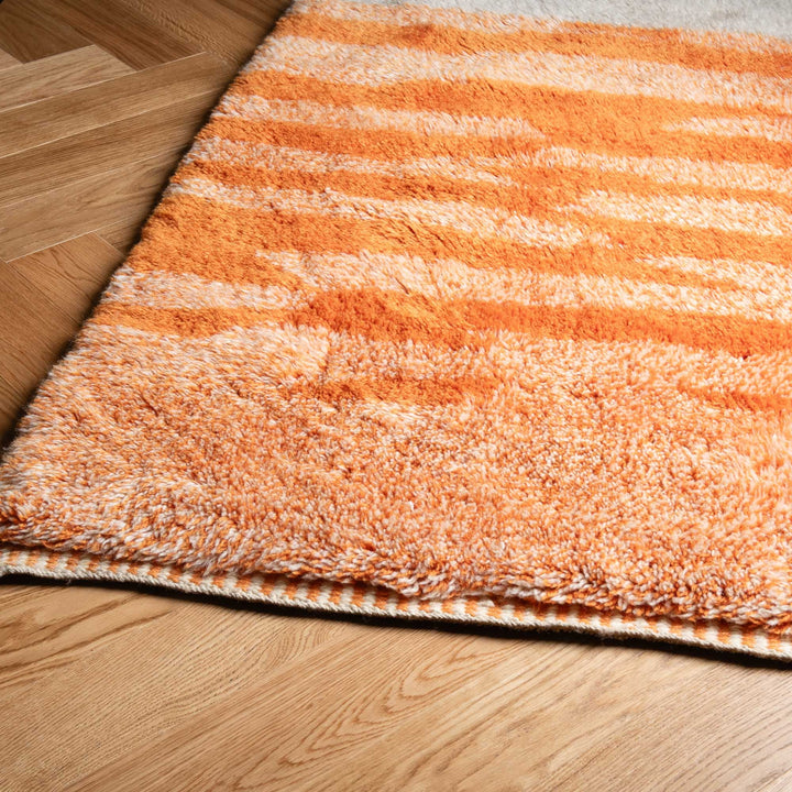 Sunrise Beni Mrirt Rug in warm tones, a handmade Moroccan wool rug with orange and terracotta stripes, perfect for cozy interiors.