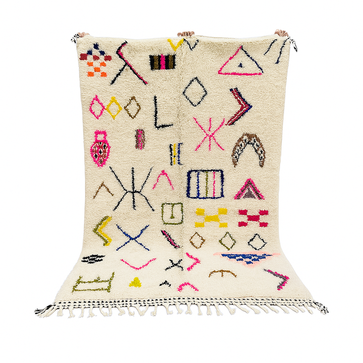 Handwoven Moroccan wool rug with cream background and colorful geometric Berber motifs in pink, blue, green, and yellow
