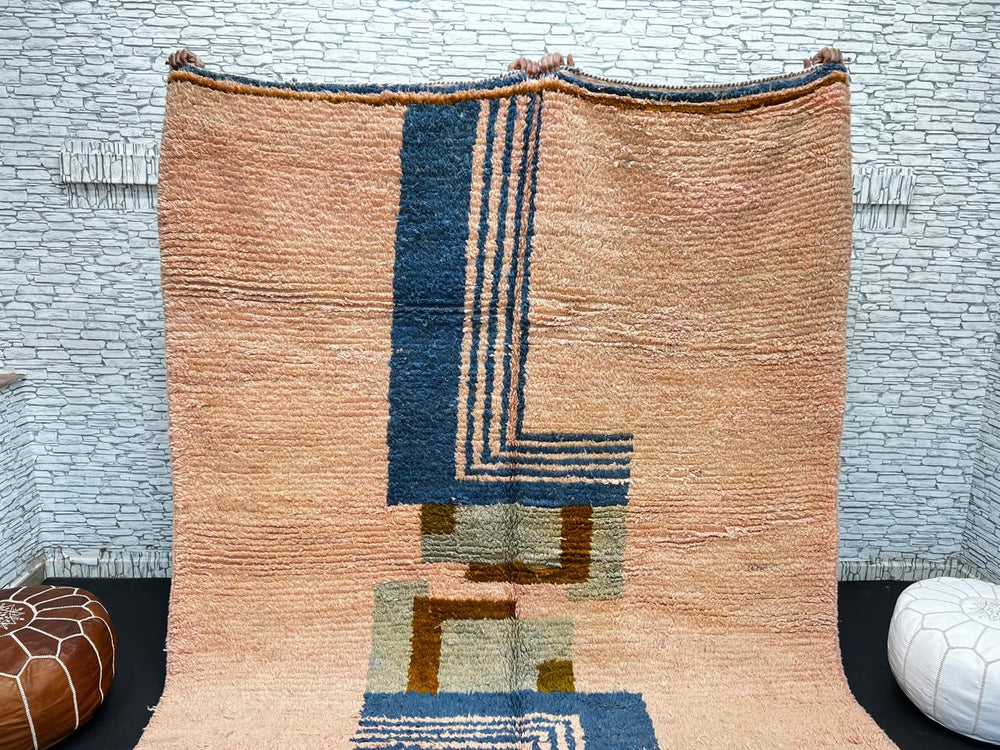 Terracotta Moroccan wool rug with blue and olive geometric shapes, handmade by Berber artisans