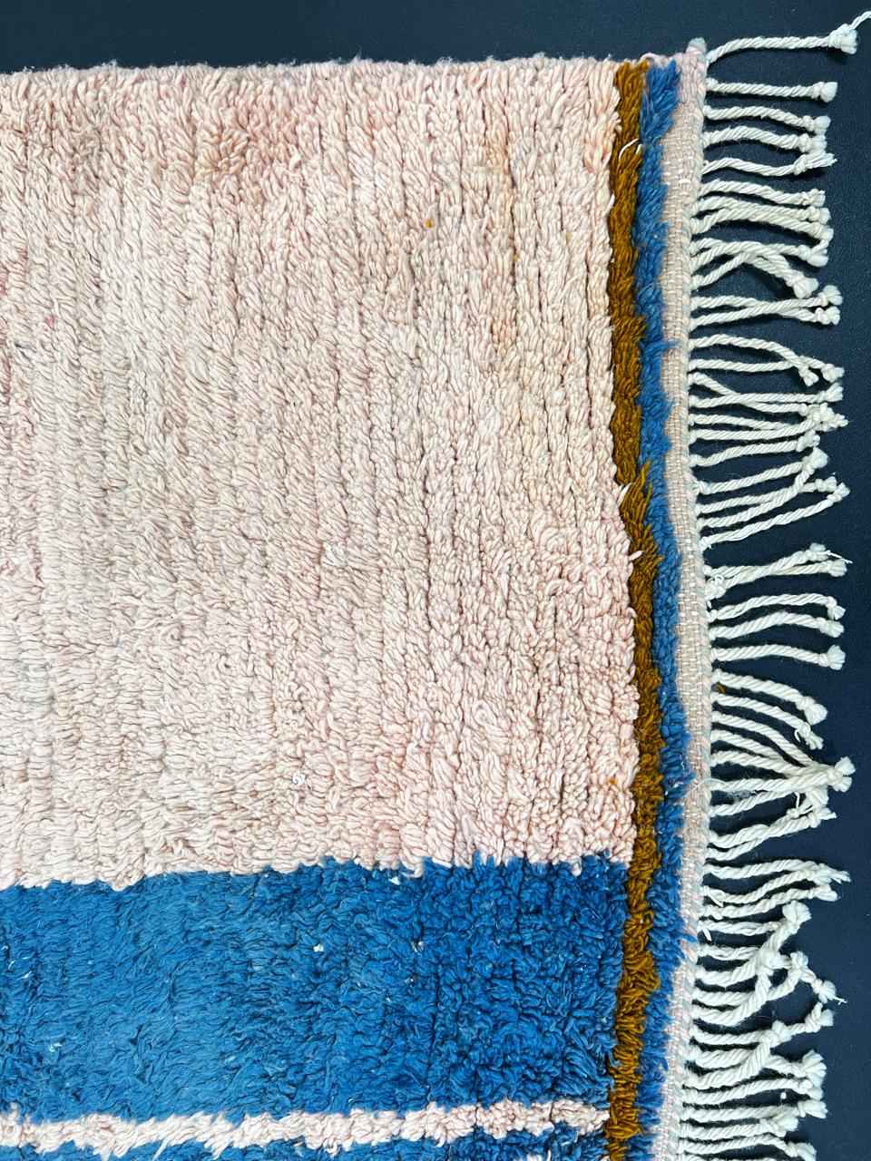 Terracotta Moroccan wool rug with blue and olive geometric shapes, handmade by Berber artisans