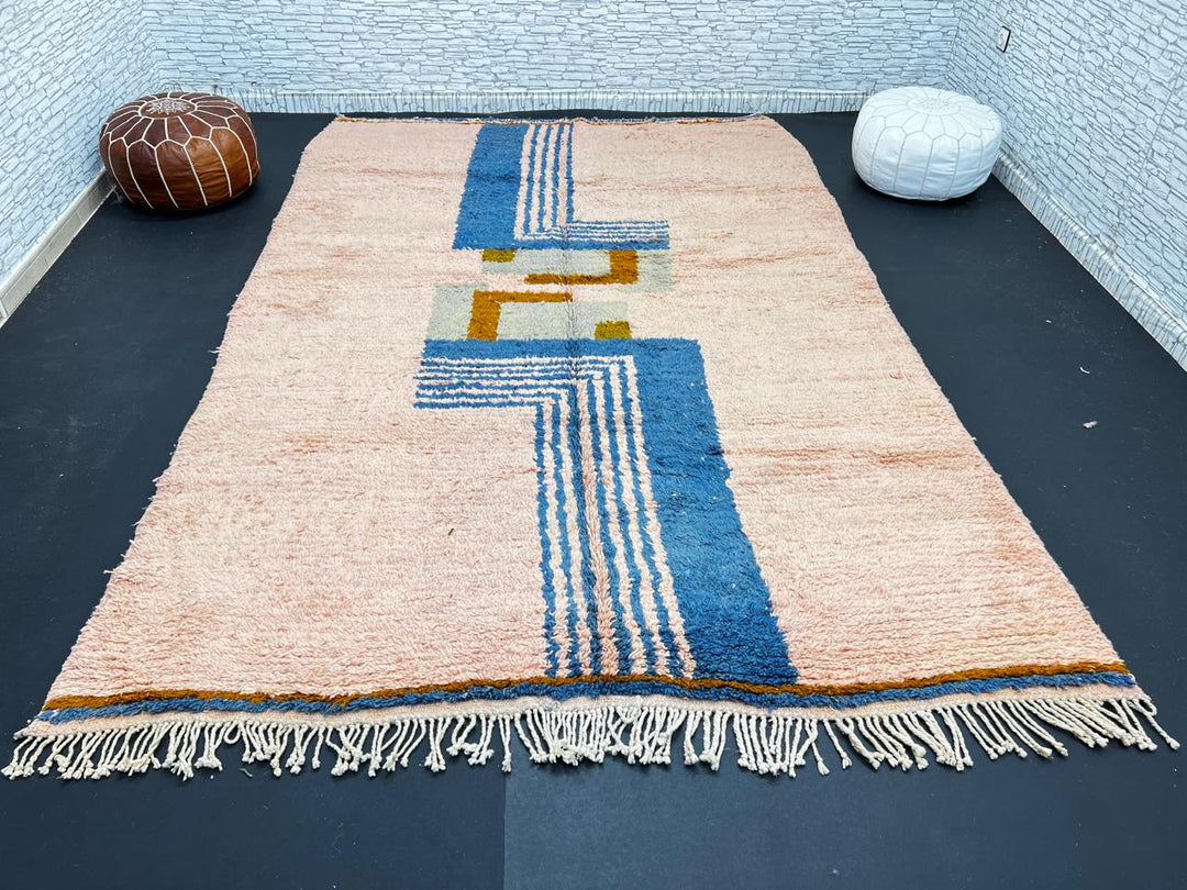 Terracotta Moroccan wool rug with blue and olive geometric shapes, handmade by Berber artisans