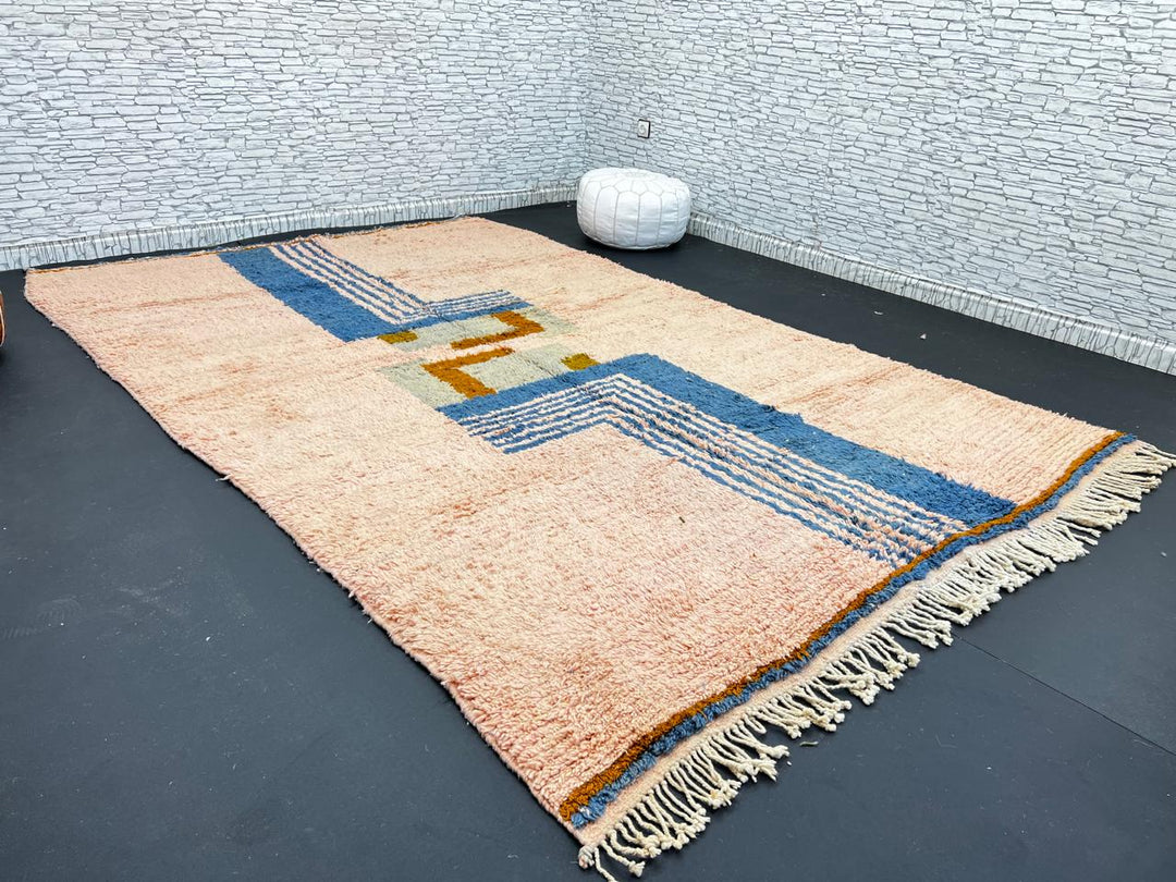 Terracotta Moroccan wool rug with blue and olive geometric shapes, handmade by Berber artisans