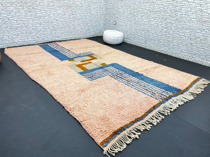 Terracotta Moroccan wool rug with blue and olive geometric shapes, handmade by Berber artisans