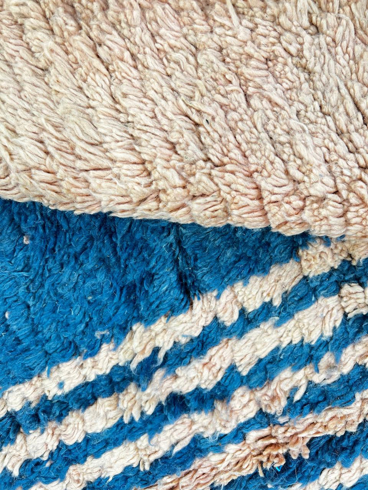 Terracotta Moroccan wool rug with blue and olive geometric shapes, handmade by Berber artisans