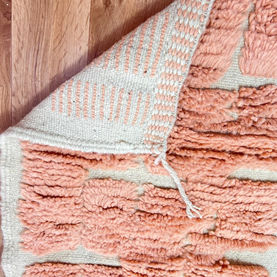 Textured peach Moroccan wool runner rug with raised Berber geometric blocks