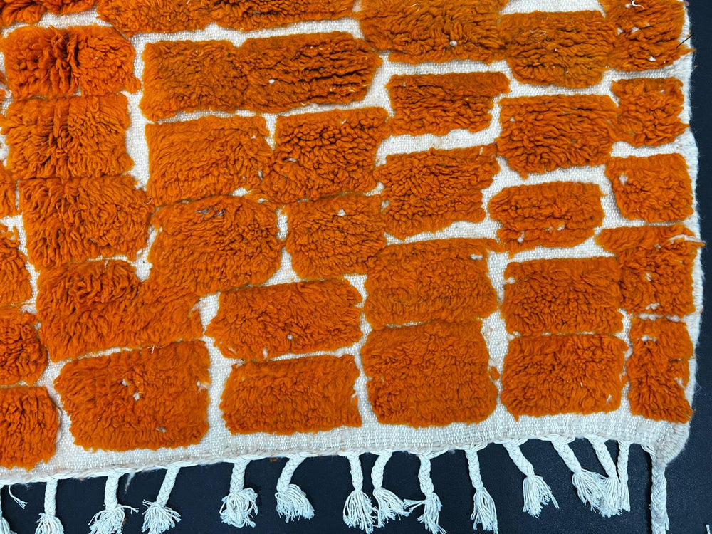Handmade orange Moroccan runner rug with textured geometric pattern in natural wool, ideal for hallway and modern boho interiors.