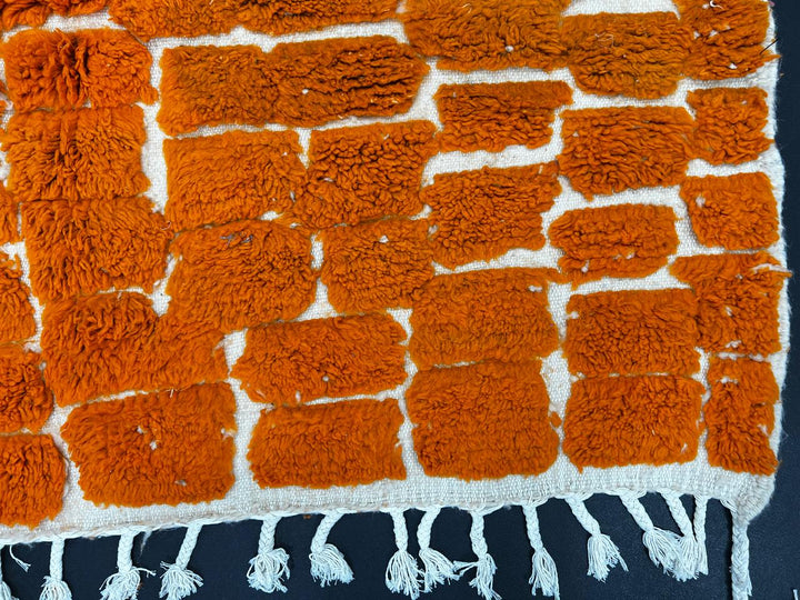 Handmade orange Moroccan runner rug with textured geometric pattern in natural wool, ideal for hallway and modern boho interiors.